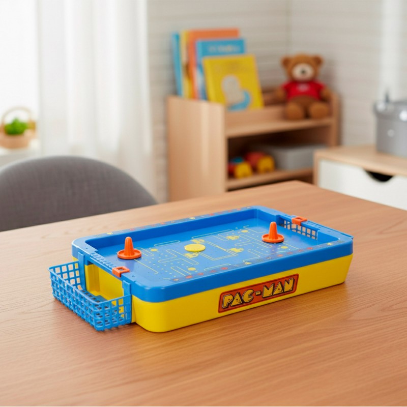 Juego de Air Hockey de mesa Pac-Man Mini Arcade colocado sobre una mesa de madera en una habitación infantil.